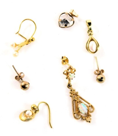 A group of 9ct gold and other earrings and pendants, comprising a 9ct gold opal set drop earring, two cultured pearl set yellow metal drop earrings, one stamped 375, a pair of 9ct gold ball studs, and two stone set pendants, in yellow metal mounts, unmark