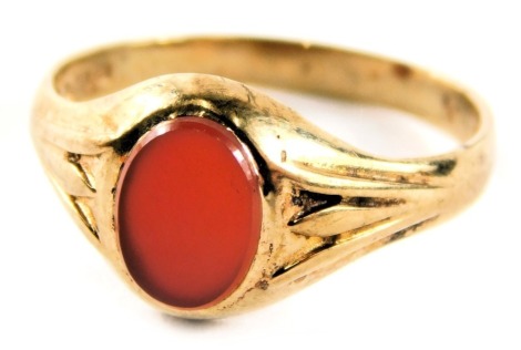 A signet ring, set with oval orange bloodstone with three splay shoulders, yellow metal stamped 9ct, ring size O, 2.1g all in.