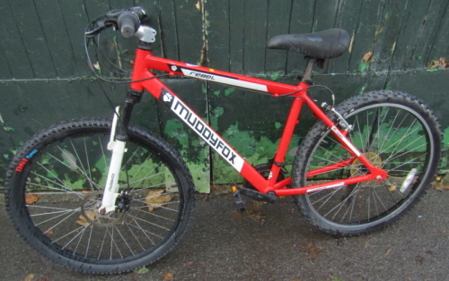 A Muddy Fox Rebel bicycle in red trim