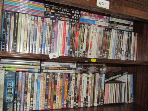 Various DVDs, to include Ghost, Collateral, Black Hawn Down, Saving Private Ryan, King's Speech, some CDs, etc. (2 shelves)