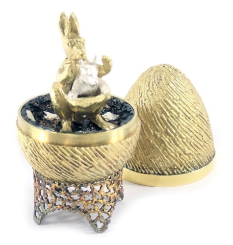 A Stuart Devlin silver parcel gilt Kangaroo and Sprung Joey egg, London 1974, with unmarked silver gilt coloured stand, 6.93oz, 7cm high, boxed with certificate.