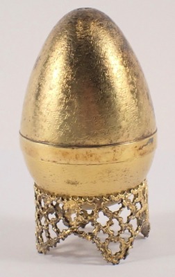 A Stuart Devlin silver parcel gilt Mad March Hare egg, the brushed egg opening to reveal a silvered hare, numbered 159 to underside, London 1973, with unmarked silver gilt coloured stand, 6.40oz, 7cm high, boxed with certificate, limited edition number 20 - 2