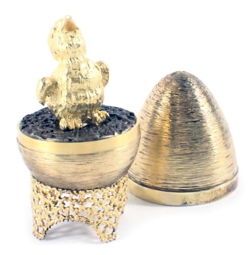 A Stuart Devlin silver parcel gilt Fledgling egg, London 1971, with unmarked silver gilt coloured stand, 6.40oz, 7cm high, boxed with certificate.