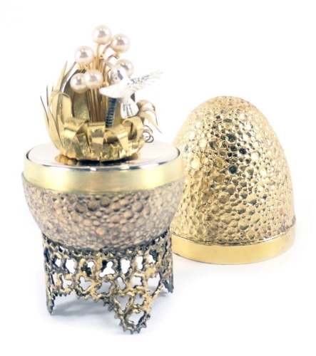 A Stuart Devlin silver parcel gilt Hummingbird egg, London 1977, with unmarked silver gilt coloured stand, 5.41oz gross, 7cm high, boxed with certificate, limited edition number 207/300.