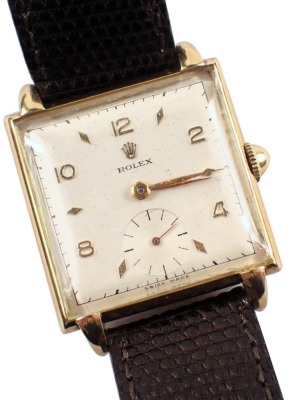 A late 1940s Rolex gent's wristwatch, with square watch head and a white interface with seconds dial and gold hands, numbered 498641, 4330, yellow metal stamped 14k 585, on a later brown leather strap, the dial 2.5cm diameter, with a seventeen rubis movem