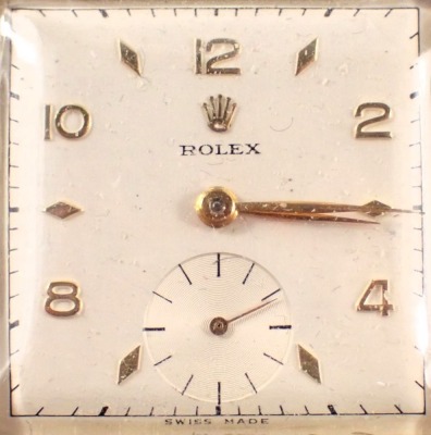 A late 1940s Rolex gent's wristwatch, with square watch head and a white interface with seconds dial and gold hands, numbered 498641, 4330, yellow metal stamped 14k 585, on a later brown leather strap, the dial 2.5cm diameter, with a seventeen rubis movem - 2