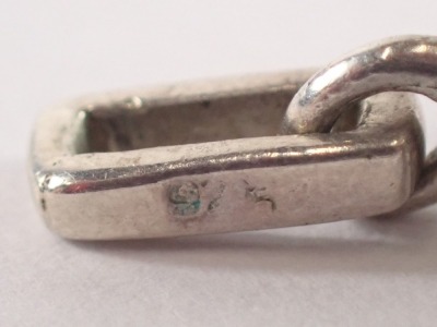 A silver child's bangle, 4cm diameter, 5.7g, a 9ct gold heart shaped locket, and a plated dice pendant. (3) - 3