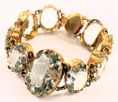 A 1920s style bracelet, with graduated pale blue oval glass beads, each in a rub over gold coloured setting, 18cm long. (AF) - 2