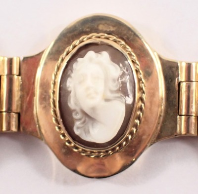 A cameo bracelet, with eight oval panels, each with raised cameo depicting female figure, in a rubbed yellow metal bracelet frame, with safety chain and clasp, stamped 375, 20cm long, 37.8g all in, boxed. - 2