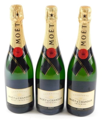 Three bottles of Moet and Chandon Imperial Brut Champagne.