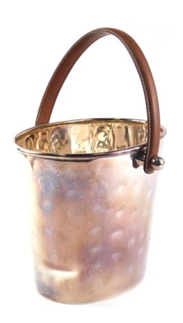 A silver plated bucket shaped wine cooler, with brown leather handle, 37cm high.