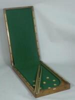 A mahogany bagatelle board retailed by Hamleys of London