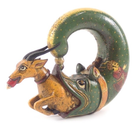 An Eastern wooden hip flask, shaped as an antler and fish, painted on a green and yellow ground, with eastern figures, 17cm diameter.