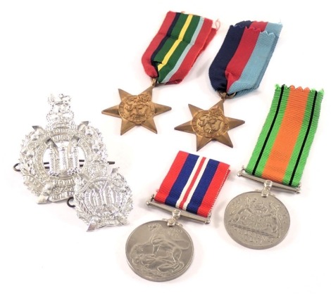 A group of WWII medals and badges, comprising defence medal, George VI coronation medal, Pacific Star and 1939-1946, unawarded with ribbons, and two reproduction cap badges. (6)