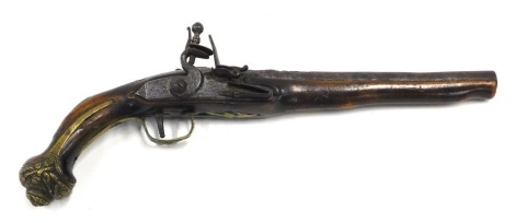 A 19thC flintlock pistol, the steel barrel embellished in brass with scroll work, indistinctly numbered with walnut stock, etc.