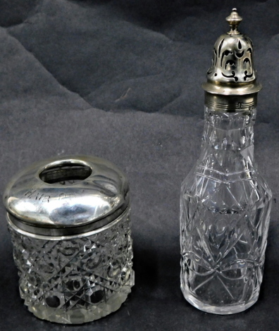 A George V silver and cut glass dressing table jar, of crest and moulded design, inscribed hair pins, and a later sugar shaker, 7cm and 15cm high. (2)