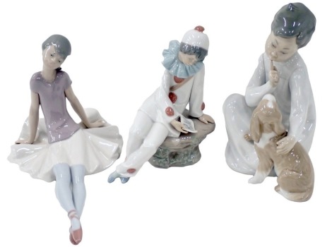 Three Lladro figures, comprising a seated child with dog, seated ballerina, and a clown, the largest 20cm high. (3)