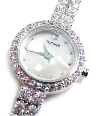 An Accurist ladies wristwatch, with a mother of pearl dial and set with white paste stones, in a stainless steel case, in fitted case.