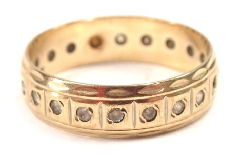 A 9ct gold eternity ring, set with white stones, with petalated border, ring size R½, 2.9g all in.