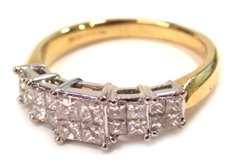 An 18ct gold diamond dress ring, with five square diamond sections, each with four square cut stones totalling 1ct overall, in platinum setting on a yellow band, ring size P½, 5.1g all in.