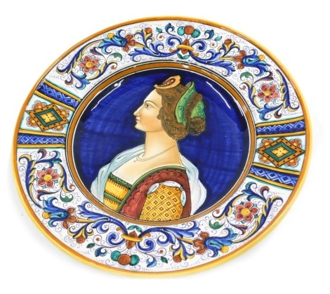 A 20thC Urbino Maiolica pottery dish, decorated with a central portrait within borders of scrolls, flowers, etc., 37cm diameter.