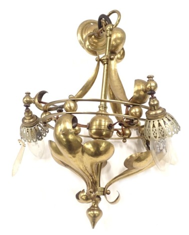 An early 20thC brass Art Nouveau light fitting, of three branch design, with shaped and fluted scrolls, 37cm high.