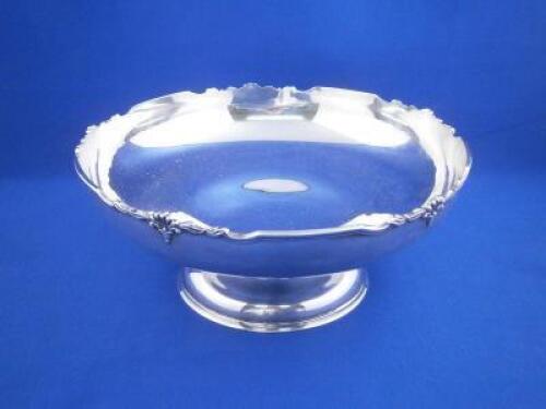 A silver bowl with a moulded edge cast with acanthus and bell flower