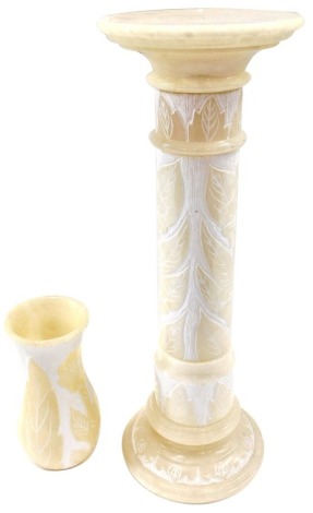 A Continental alabaster jardiniere, carved with leaves and flowers, etc., and matching vase, 92cm high overall.