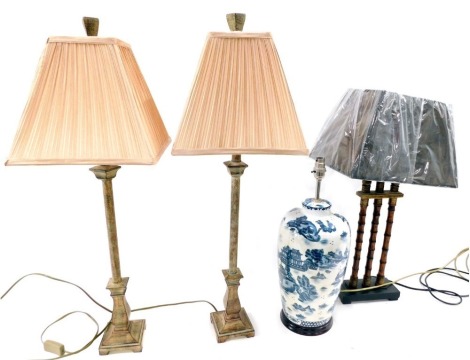 A collection of table lamps, to include a resin lamp painted to simulate bamboo, with shade, 66cm high, a Chinese style blue and white lamp base, and a pair of bronze effect lamps.