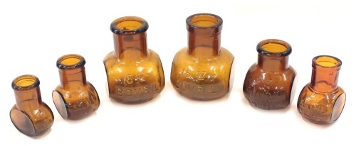 Bovril jars, from 16oz to 4oz, comprising six jars, brown ground, the largest 12cm high, the smallest 8cm high, 37cm long overall.