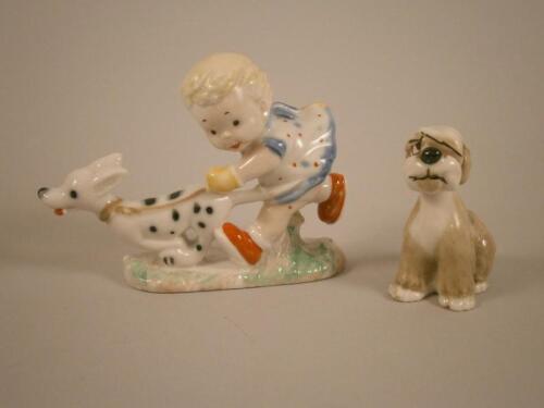 A Wade Mabel Lucie Attwell porcelain figure of a young girl with a dog and a small Wade type figure