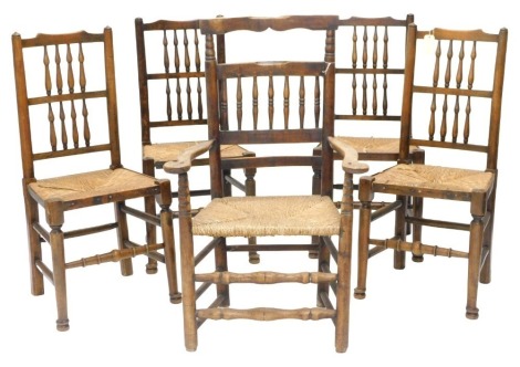 A set of four 19thC style beech country made spindle back chairs, each with turned legs and stretchers, and an associated 19thC armchair.