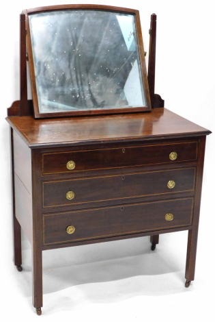 An Edwardian mahogany and boxwood strung dressing table, with rectangular mirror with arched top, above an arrangement of three drawers, on plain legs, 82cm wide.