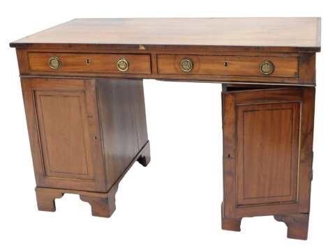 A mahogany and ebony strung pedestal desk, the rectangular top with two frieze drawers above two panelled doors, on bracket feet, 120cm wide.