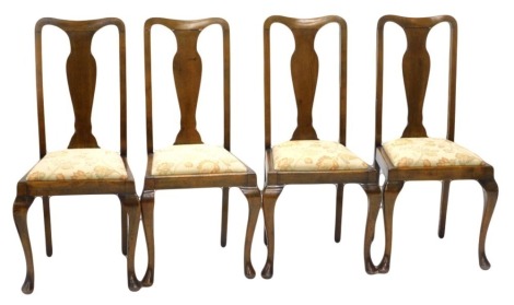 A set of four early 20thC stained beech dining chairs, in Queen Anne style, each with a padded seat, on cabriole legs.