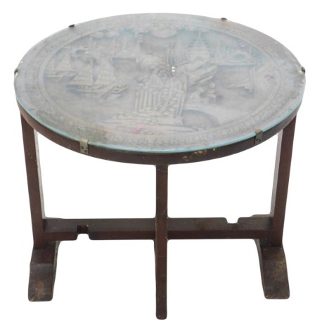 A Chinese hardwood occasional table, circular tilt top carved with figures, boats, buildings, etc., on plain supports, 80cm diameter.