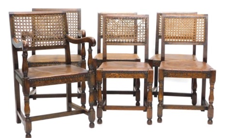 A set of six early 20thC oak dining chairs, each with a caned back and a brown leatherette padded seat on turned supports. (AF)