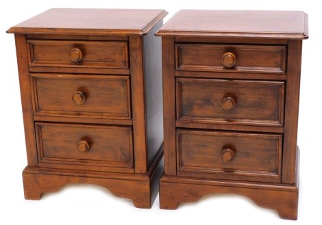 A pair of Continental cherrywood bedside cabinets, each with three drawers on bracket feet, 48cm wide.