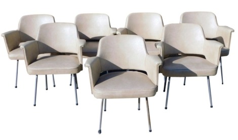 A set of seven 1950s beige vinyl office elbow chairs, with chrome frames. The upholstery in this lot does not comply with the 1988 (Fire & Fire Furnishing) Regulations, unless sold to a known exporter or upholsterer it will be cut from the frame before le