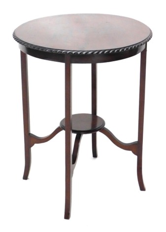 An Edwardian mahogany occasional table, circular top, on plain supports, 56cm wide.