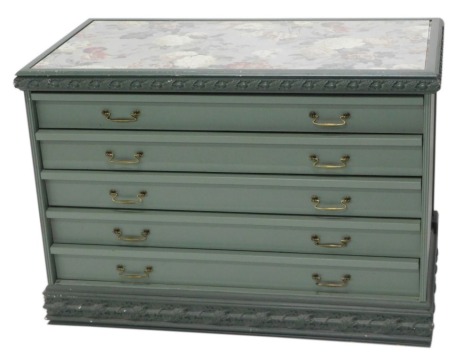 A Continental green painted chest of drawers, the glazed top inset with floral fabric panel and with leaf and berry carved borders to the top and plinth, above five drawers, with brass drop handles, 84cm high, 120cm wide, 56cm deep.