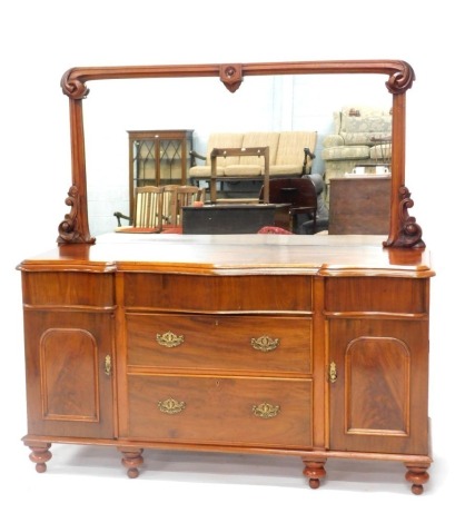 A late Victorian mahogany sideboard, with mirror back, the serpentine fronted top with a moulded edge, above arrangement of five drawers and two doors, on turned legs.