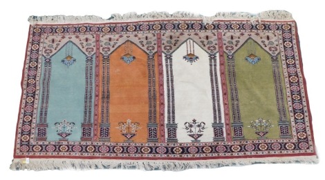 A Turkish Anatolian style multicoloured rug, decorated with chandeliers of light fittings, vases of flowers, in blue, cream, orange and turquoise, one wide and two narrow borders, 216cm x 105cm.