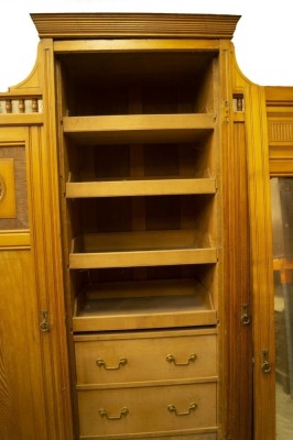 A late Victorian aesthetic movement light ash wardrobe compactum and dressing table by Shapland & Petter, the wardrobe having centre moulded cornice and gallery sides, the central fitted mirror door having press drawers over three solid and flanked by ros - 2