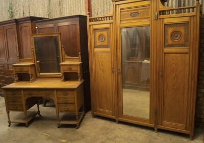 A late Victorian aesthetic movement light ash wardrobe compactum and dressing table by Shapland & Petter, the wardrobe having centre moulded cornice and gallery sides, the central fitted mirror door having press drawers over three solid and flanked by ros - 3