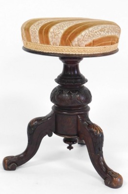 A Victorian mahogany revolving piano stool, with overstuffed upholstered seat, above a lappet and foliate carved column over three leaf carved cabriole legs, 52cm high, together with a Georgian country dining chair. (2) - 2