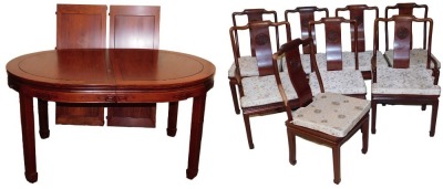 A Chinese hardwood oval dining table, with two additional leaves, raised on square legs and spade feet, 77cm high, 152cm wide, 244cm extended, 112cm deep, together with eight dining chairs, with loose cushion seats, comprising a pair of carvers and six si