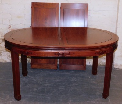 A Chinese hardwood oval dining table, with two additional leaves, raised on square legs and spade feet, 77cm high, 152cm wide, 244cm extended, 112cm deep, together with eight dining chairs, with loose cushion seats, comprising a pair of carvers and six si - 2