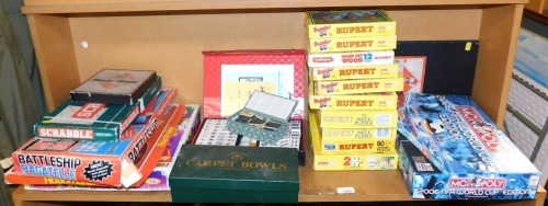 Games, to include Scrabble, Monopoly, carpet bowls, Mahjong, various Rupert The Bear puzzles, FIFA 2006 Monopoly. (1 shelf)