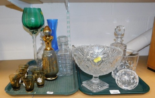 Glassware, to include cut glass centre bowl, fruit bowl, decanters, glass, decorative glassware with gilt decoration. (2 trays)